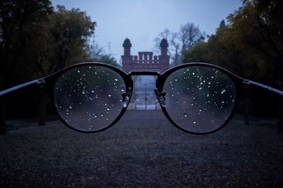 Close-up of sunglasses against sky