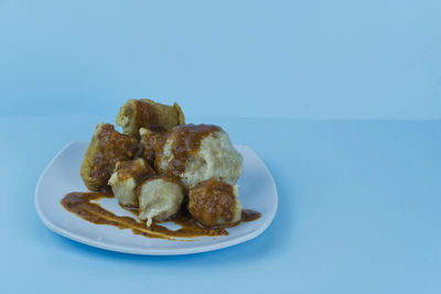 Close-up of food in plate on white background