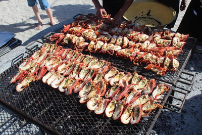 High angle view of people preparing food on barbecue grill