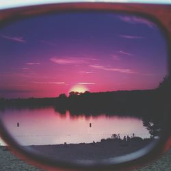 Reflection of clouds in sea at sunset