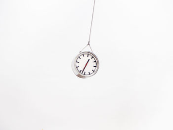 Close-up of clock over white background