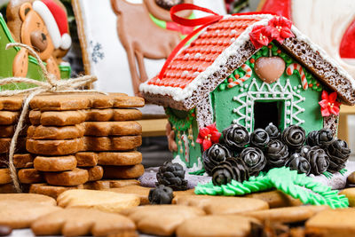 Close-up of cookies and gingerbread house on table