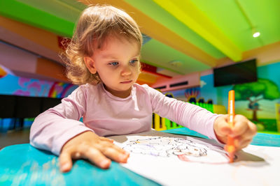 Portrait of boy drawing on table