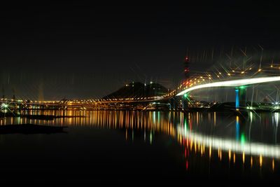 Illuminated city against clear sky at night
