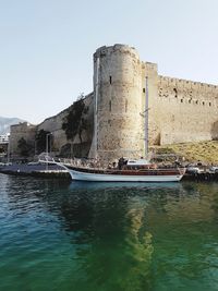 Built structure in sea against clear sky