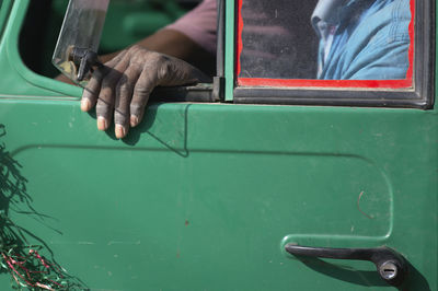 Midsection of man sitting in van