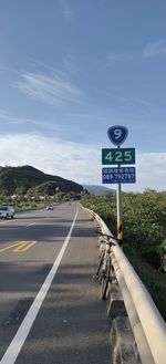 Road sign against sky