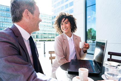 Portrait of business colleagues working at table