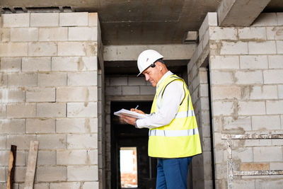 Side view of engineer working at construction site