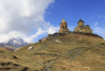 Low angle view of trinity church in gergeti, georgia, asia 