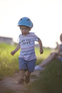 Portrait of boy standing on field