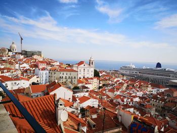 High angle view of townscape by sea against sky