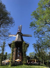 Low angle view of traditional windmill against sky