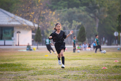 Full length of girl running on field