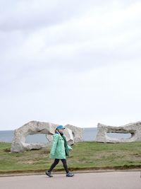 Full length of man standing by sea against sky