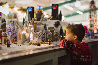 Close-up of boy looking at christmas decoration