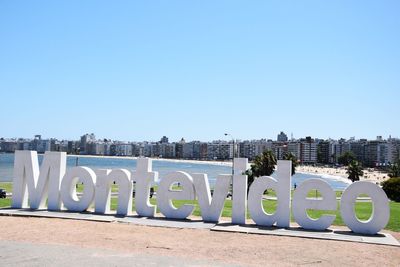 Information sign against clear blue sky