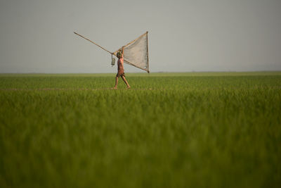 Boy walking on field