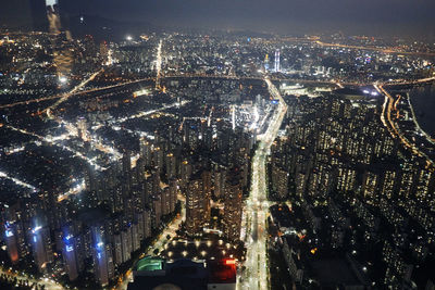 Aerial view of city lit up at night