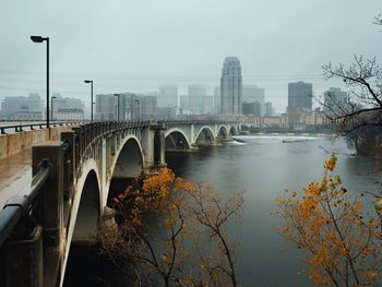 Hennepin avenue bridge over river in city during rainy season