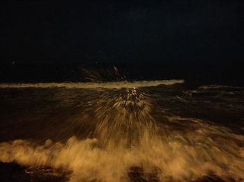 Close-up of illuminated moon over sea against sky