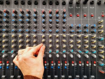 Cropped hand of woman using sound mixer