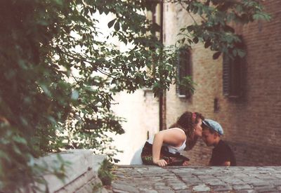 Young couple sitting on tree