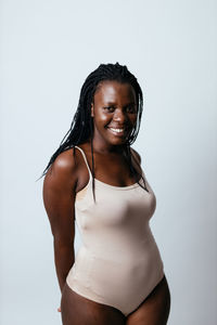 Portrait of smiling woman against white background