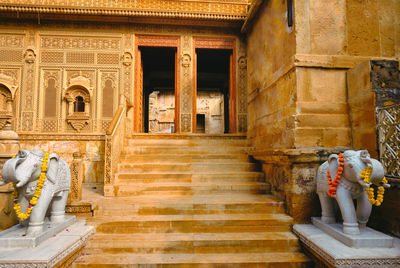 Rear view of people walking on staircase of building