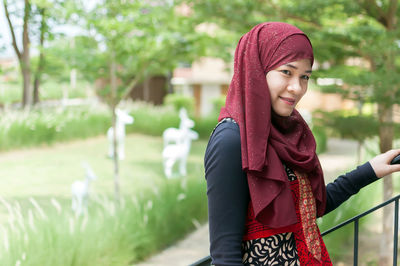 Portrait of woman in hijab standing at park