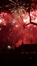 Low angle view of firework display at night