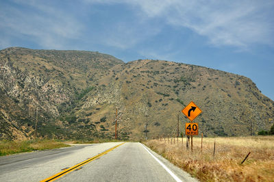 Road sign against sky