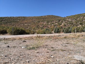 Surface level of land against clear blue sky