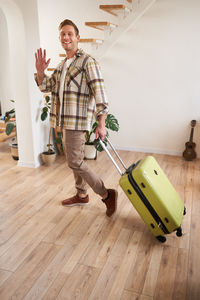 Portrait of young man standing on floor