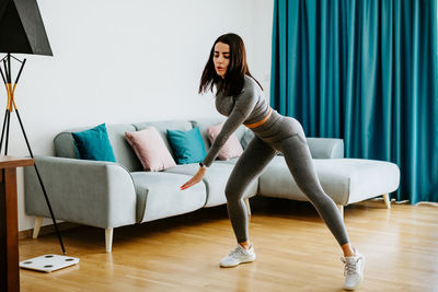 Side view of young woman at home