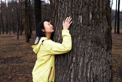 Young woman standing in forest