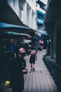 People walking on footpath in city