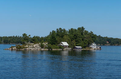 Scenic view of lake by trees against sky