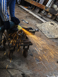 Low section of man working on wood