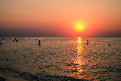 Scenic view of sea against orange sky