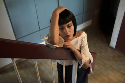 Young woman leaning on railing