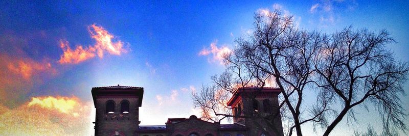 Low angle view of houses against sky at sunset