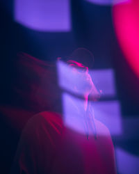 Close-up of thoughtful man wearing cap in illuminated room