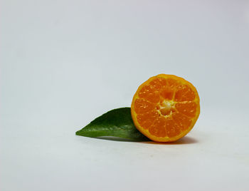 Close-up of orange slice against white background