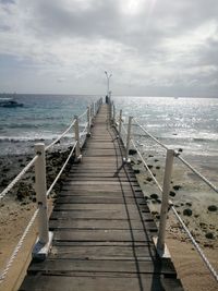 Pier over sea against sky