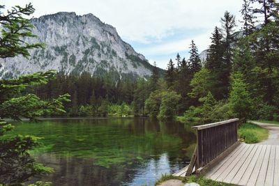 Scenic view of lake by mountain against sky