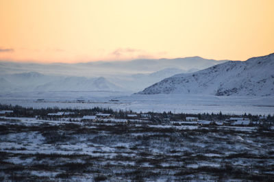 Scenic view of frozen lake against sky during sunset