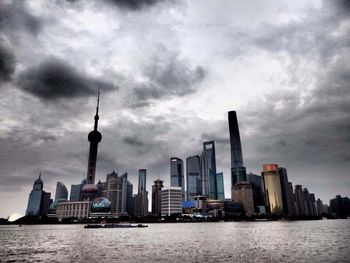 City skyline against cloudy sky