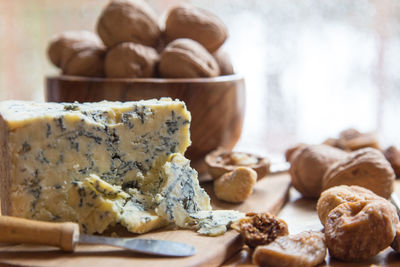 Close-up of walnuts with cheese on table