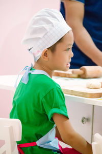 Close-up of boy making food